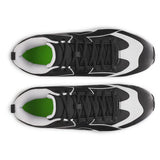 Top view of black and white sneakers with green accents on a white background