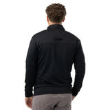 A man viewed from behind wearing a black long-sleeve quarter-zip pullover and gray pants, set against a plain white background.