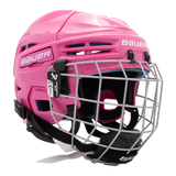 A pink Bauer hockey helmet with a silver wire face cage, black chin straps, and a white Bauer logo on the side, shown against a plain white background.