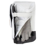 A white goalie blocker with black and gray protective padding, shown with a gray glove inserted into the front opening, on a solid white background.