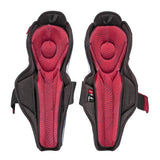 A pair of black and red protective shin guards shown from the front on a plain white background.