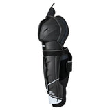 A black hockey shin guard with white accents and a hook-and-loop strap closure, shown from a side profile view on a white background.