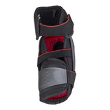 A black hockey shin guard with red lining and a gray mesh panel on the lower front, shown against a plain white background.