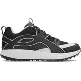 Black and white golf shoe with cleats on a white background