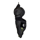 Black hockey shin guard with a dark gray patterned inner panel and small yellow accents, shown from the side on a white background.