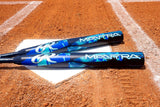 Two Mantra baseball bats with blue and black graphics resting on a white home plate on a dirt baseball field.