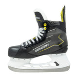 A single Bauer ice skate boot in black with yellow and white accents, featuring a white plastic blade, shown against a plain white background.