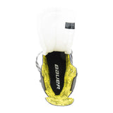 Bauer hockey shin guard shown from the back, featuring a white padded insert, a black central backing with the white Bauer logo, and a bright yellow textured outer shell.