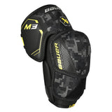 Black and gray elbow pad with yellow accents on a white background