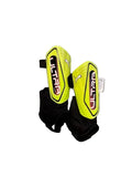 Pair of yellow shin guards with 'Ultra' branding on a gray surface