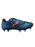 Black soccer cleat with red logo on a wooden floor
