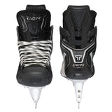 Pair of black hockey skates with white accents on a white background