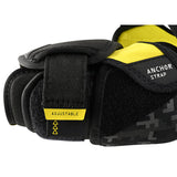 Black and yellow wrist support with adjustable strap on a white background