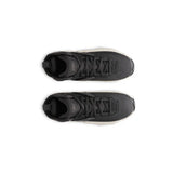 Top-down view of black sneakers on a white background