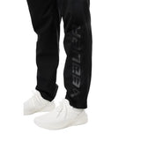 Black Bauer pant with white shoes on a white background