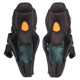 Pair of black knee pads with orange accents on a white background