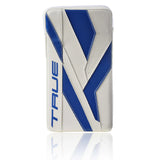 A hockey goalie blocker in white and blue, featuring the brand name 'TRUE' vertically on the left side, set against a clean white background with a subtle reflection below.