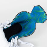 Close-up of a skates with a blue and green pattern on the sole against a white background
