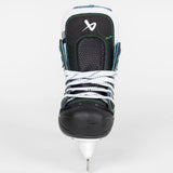 A single ice skate boot shown from the front on a light gray studio background. The boot is predominantly black and white with bright green stitching accents and a white blade attached at the bottom.