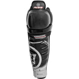 Black and gray Warrior Rise hockey shin guards on a white background